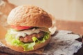 Close-up photo of home made hamburger with beef, onion, tomato, lettuce, cheese and spices. Fresh burger closeup on Royalty Free Stock Photo