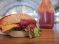 Close-up photo of home made hamburger with beef, onion, tomato, lettuce, cheese and spices. Fresh burger closeup on wooden rustic Royalty Free Stock Photo