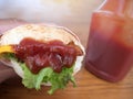 Close-up photo of home made hamburger with beef, onion, tomato, lettuce, cheese and spices. Fresh burger closeup on wooden rustic Royalty Free Stock Photo