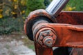 Close up photo of the hydraulic system with orange excavator boom