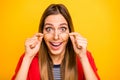 Close up photo of impressed millennial touching her specs screaming wearing red striped shirt jacket isolate over yellow Royalty Free Stock Photo