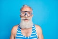 Close up photo of impressed old man wearing striped bathing suit  over blue background Royalty Free Stock Photo
