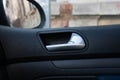 Close up photo inside a car, door handle isolated