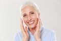 Close-up photo of laughing gray-haired senior woman, looking at