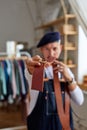 close-up photo of leather brown belt in hands of craftsman Royalty Free Stock Photo