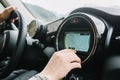 Close-up photo of leather interior and dashboard in the car. Man driving around new city and using navigator to avoid Royalty Free Stock Photo