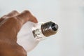 close up photo of a light bulb in a man& x27;s hand, isolated on a white background. Royalty Free Stock Photo