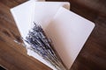 Close-up photo of light pink scheduler notebook on a wooden table with lavender.