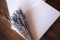 Close-up photo of light pink scheduler notebook on a wooden table with lavender.