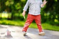 Close-up photo of little kid boy drawing with colored chalk on asphalt. Royalty Free Stock Photo