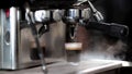 Close up photo of making coffee with machine in cafe. Professional modern espresso coffee machine pours hot drink into the cup. Royalty Free Stock Photo