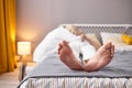 Close-up photo of male bare feet, dying sick man lying on bed Royalty Free Stock Photo