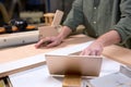 Close-up photo of male carpenter hands using digital tablet during work Royalty Free Stock Photo