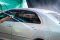 Close up photo of a man hands washes his car with a large head of water from a karcher on open air. Cleaning and disinfection. Car Royalty Free Stock Photo