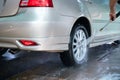 Close up photo of a man hands washes his car with a large head of water from a karcher and washing car with soap. Cleaning and Royalty Free Stock Photo