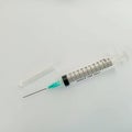 Close-up photo of a medical syringe and transparent cap on a white background Royalty Free Stock Photo