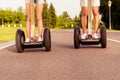 Close up photo of man and woman riding electric gyropode Royalty Free Stock Photo