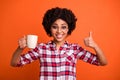 Close up photo of model wavy lady hold hands hot beverage mug thumb up symbol morning wear casual checkered plaid shirt