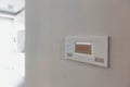 Close up photo of modern temperature touch switch board on wall