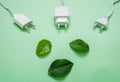 Close up photo of multiple unplugged charging sockets and green leaves. Royalty Free Stock Photo