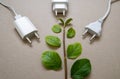 Close up photo of multiple unplugged charging sockets and green leaves. Royalty Free Stock Photo