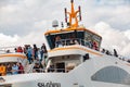 Close up photo of new passenger ferry leaving the pier in Istanbul. People taking fresh air, enjoying the scenery during transport