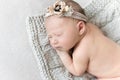 Close-up photo of newborn baby girl sleeping on a knitted blanket. Royalty Free Stock Photo