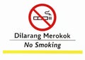 Close up photo of a no smoking sign for everyone in the area. usually found in public service places.