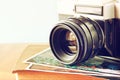 Close up photo of old camera lens over wooden table. image is retro filtered. selective focus