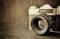 Close up photo of old camera lens over wooden table. image is retro filtered. selective focus