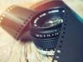 Close up photo of old camera lens over wooden table. Image is retro filtered. selective focus, lens flare Royalty Free Stock Photo