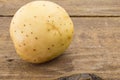 Close up photo of one potato on rustic wood Royalty Free Stock Photo