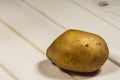 One potato on wodden table Royalty Free Stock Photo