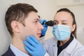 close up photo of a optometrist examining man`s eyes