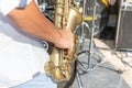 Close up photo of outdoors musician playing saxophone at jazz festival
