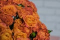 Close-up photo of a part of huge bouquet of roses, against white brick wall background. Royalty Free Stock Photo