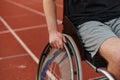 Close up photo of a person with disability in a wheelchair training tirelessly on the track in preparation for the Royalty Free Stock Photo