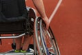 Close up photo of a person with disability in a wheelchair training tirelessly on the track in preparation for the Royalty Free Stock Photo