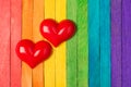 Close up photo picture of two bright color red hearts isolated multicolored wooden desk Royalty Free Stock Photo