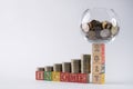 Close-up photo of Piggy bank set on wooden blocks number 2017 with golden coins in money jar. Royalty Free Stock Photo