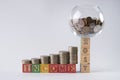 Close-up photo of Piggy bank set on wooden blocks number 2017 with golden coins in money jar. Royalty Free Stock Photo