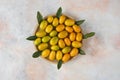 Close up photo, Pile of kumquats on wooden plate