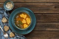 Close-up photo of plate with fresh homemade pumpkin cream soup with seeds and heart shape toasts on vintage wooden background. Royalty Free Stock Photo