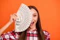 Close up photo portrait of astonished with opened mouth toothy smile lady hiding her face behind stack of money isolated Royalty Free Stock Photo