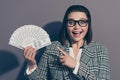 Close up photo portrait of laughing cheerful she her lady demonstrating many lot much money in hand looking at camera Royalty Free Stock Photo
