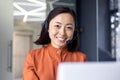 Close up photo portrait of young beautiful Asian woman, business woman smiling and looking at camera, receptionist using Royalty Free Stock Photo