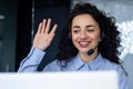 Close-up photo. Portrait of a young Muslim woman, a student in an overalls, studying at a laptop, smiling, talking on a Royalty Free Stock Photo