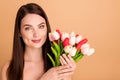 Close up photo of positive cheerful girl enjoy present for 8-march hold flowers given after colage beauty spa salon