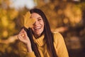 Close up photo of positive cheerful girl nature lover enjoy travel fall park grove laugh close cover eye face maple