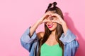 Close up photo of positive cheerful girl teen make heart shape love symbol figure watch eye face look after her Royalty Free Stock Photo